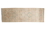Distressed Serab runner, faded beige field, repeating medallions, visible wear. 3'3