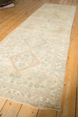 Distressed vintage Serab runner with geometric medallion, beige, sand, and pale green boteh motifs.