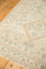 Distressed vintage Serab runner showing geometric botehs and pale, sea foam green motifs.