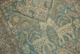 Articulated texture of worn seafoam green and beige Heriz patterns showing foundation.