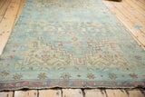 Distressed Malayer rug border with soft abrashes, geometric details, and frayed fringe.