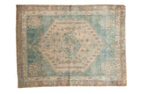 Vintage distressed Persian Afshar rug, central medallion, geometric patterns in aqua blue and sand tones.