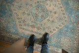 Worn aqua blue and sand geometric patterns on a vintage distressed Afshar rug.
