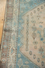 Distressed aqua blue and sand geometric patterns showing wear on a vintage Afshar rug.