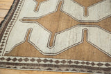 Hand-knotted Gabbeh rug detail showing geometric patterns and diamond inner border.