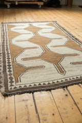 Fringe and small diamond motif on charcoal brown inner border of vintage Gabbeh rug.