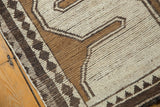 Hand-knotted vintage Gabbeh rug detail with antique ivory, copper, and charcoal small diamond border.