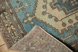 Distressed Sirjan carpet: aqua blue and sand geometric pile, with exposed hand-knotted reverse.