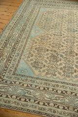Distressed Malayer rug corner, low pile Herati motif, Mir Serbend border, sand, blue, brown tones.