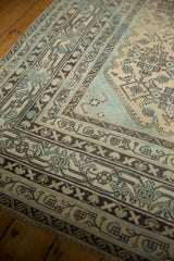 Distressed Malayer carpet, detailing the Mir Serbend border and Herati motif in pale blue.