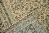 Distressed Malayer carpet corner showing low pile, Herati motif, and hand-knotted foundation.