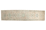 Distressed Karaja rug runner featuring geometric medallions and vinery in ivory, pale silver, brown.