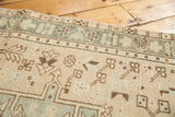 Close-up of distressed Karaja runner, geometric vinery pattern in soft beige and pale silver.