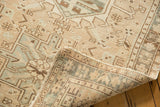 Distressed pile of vintage Karaja runner featuring beige and pale silver geometric vinery.