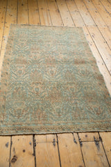 Distressed Borchalou rug shows allover floral design, low pile, peachy blush, and sky blue.