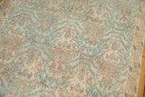 Vintage distressed Borchalou rug showcasing low pile, peachy blush, sky blue allover design.