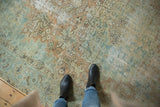 Distressed vintage Heriz rug featuring intricate floral arabesques in soft powder blue and apricot.