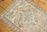 Muted geometric motifs and serrated leaves in sandy beige, ivory, and sky blue.