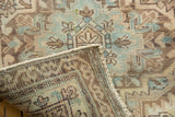 Distressed muted pile and hand-knotted foundation with secured edge on Serab runner.