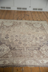 Distressed Southwestern geometric patterns and low pile on vintage Shiraz carpet, fringe detail.
