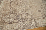 Distressed geometric Abadeh corner and field patterns in antique ivory and beige with even low pile.