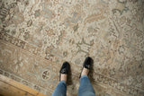 Distressed vintage Heriz rug showcasing faded geometric plant motifs and time-softened earthy tones.
