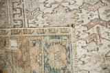 Hand-knotted foundation of the vintage Heriz, with worn geometric neutral pile.
