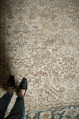 Distressed Heriz carpet with geometric field, muted colors, abashes, and mostly even wear.