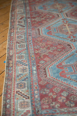 Distressed Qashqai rug runner, detailed view of geometric serrated leaf border pattern.