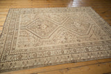 Vintage Distressed Shiraz rug detail: geometric borders and floral field patterns in sand and chocolate brown.