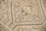 Detail of a vintage distressed Shiraz rug, featuring geometric medallions and soft, even wear.