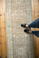 Distressed Karaja rug runner with geometric vinery, faded ivory tones, and low pile wear.