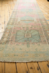 Fringed end of a Karaja runner, highlighting its geometric border and pastel worn aesthetic.