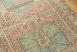 Distressed Karaja rug detail with geometric vinery, hooks, and pastel blue, pink, worn ivory.