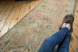 Distressed vintage Serab runner featuring geometric medallions, pawn motif, and faded ivory, bronze, teal.