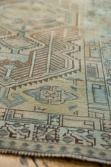 Distressed Serab runner's outer border with geometric pawn motif in faded teal, bronze, and sand.