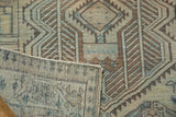 Distressed vintage Serab runner with geometric motifs in bronze, sand, dusty teal, and visible foundation.