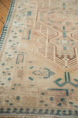 Geometric renderings and finned vinery on a distressed Serab runner in ivory and dusty teal.