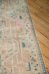 Vintage distressed Serab runner close-up showcasing worn texture, geometric motifs in ivory, rose, and teal.