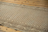Distressed ivory and chocolate brown Mir Serbend runner corner, with geometric border.