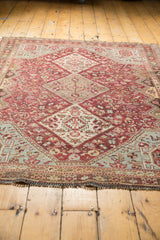 Low-angle perspective on a vintage Qashqai rug, detailing the even wear and secure fringed end.