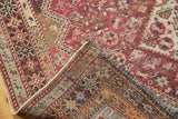 Folded corner of a distressed Qashqai rug showing its colorful hand-knotted back.