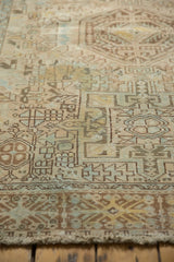 Angled view of distressed Karaja rug's geometric pattern, with worn pile revealing faint foundation.