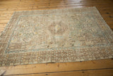 Distressed geometric border of a vintage Karaja rug in sand, brown, and powder blue.