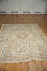 Distressed Persian Karaja rug with even wear, muted ivory and powder blue geometry.