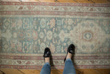 Vintage distressed Persian Malayer runner with pale blue and raspberry floral pattern, soft pile.
