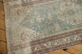 Vintage Malayer rug with distressed texture, faded raspberry and powder blue floral field.