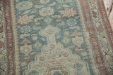 Distressed Malayer rug with faded ivory geometric motifs on sea foam field and raspberry border.