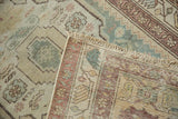 Faded floral patterns on distressed vintage Malayer rug pile, revealing tightly woven foundation.