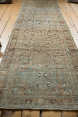 Distressed beige and powder blue pile texture with foundation showing on vintage Ahar runner.